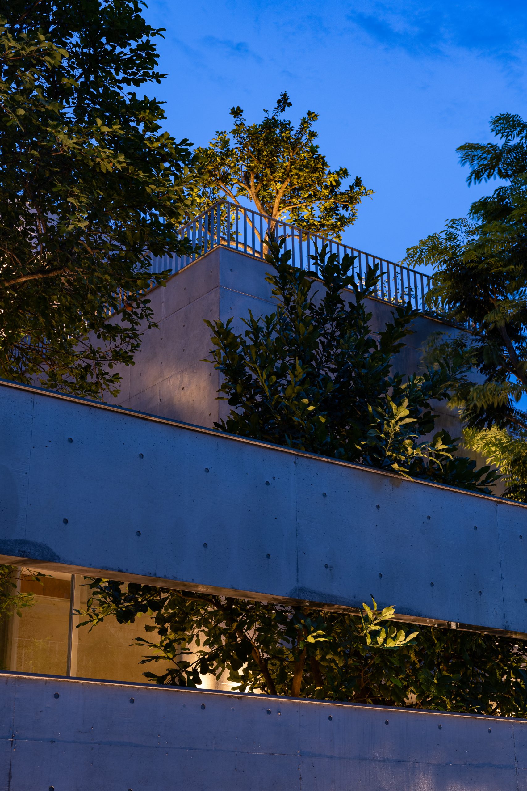 Street elevation at dusk, House K by HGAA