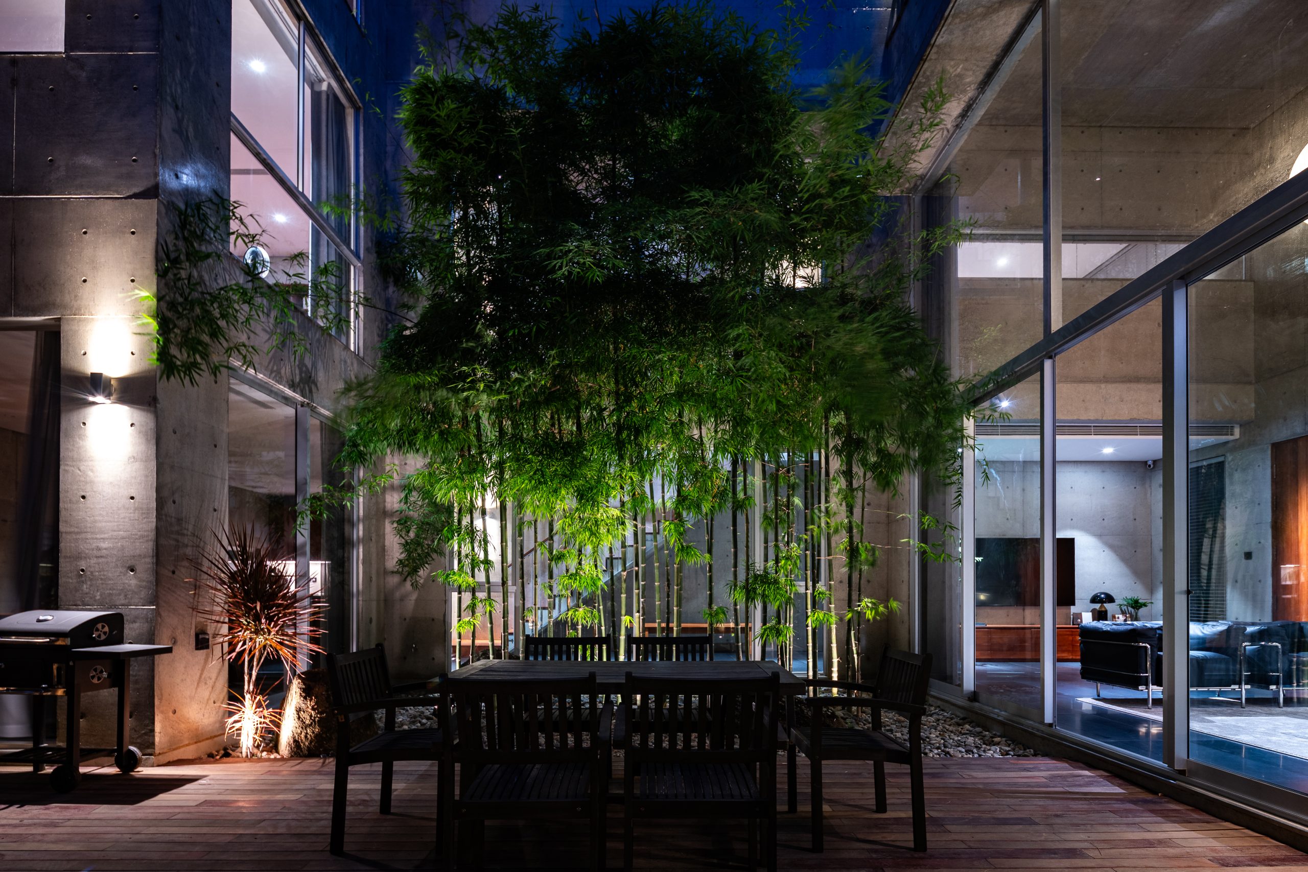 Courtyard table illuminated at night, House K by HGAA