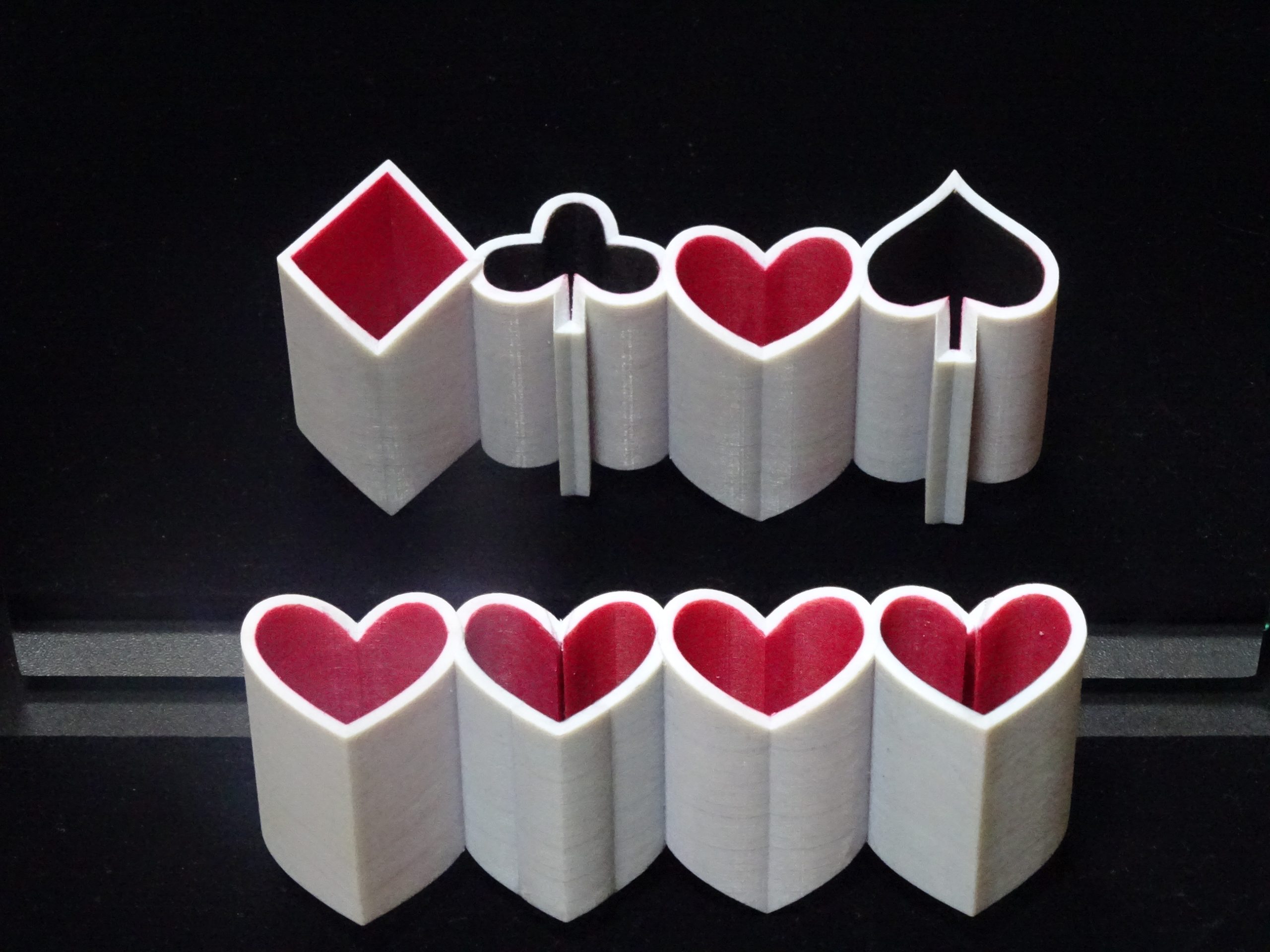Heart-shaped objects reflected as playing-card suits, Fickle Heart, 2020, by Kokichi Sugihara