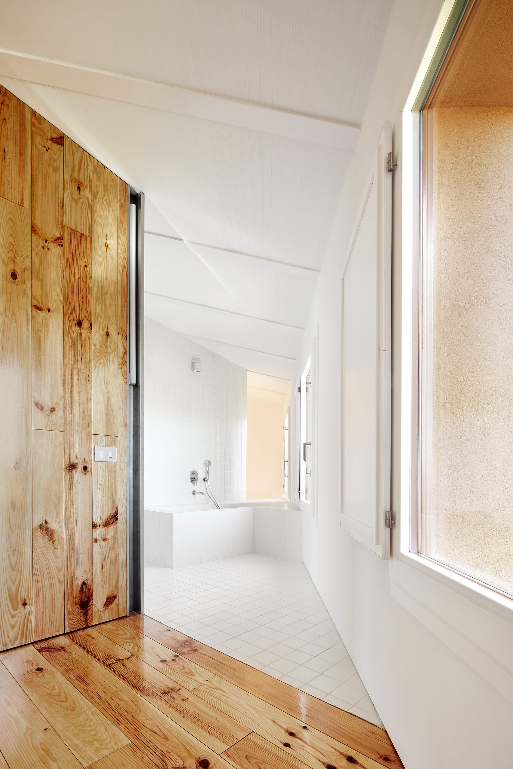 Timber partition and white interior at Can Migris