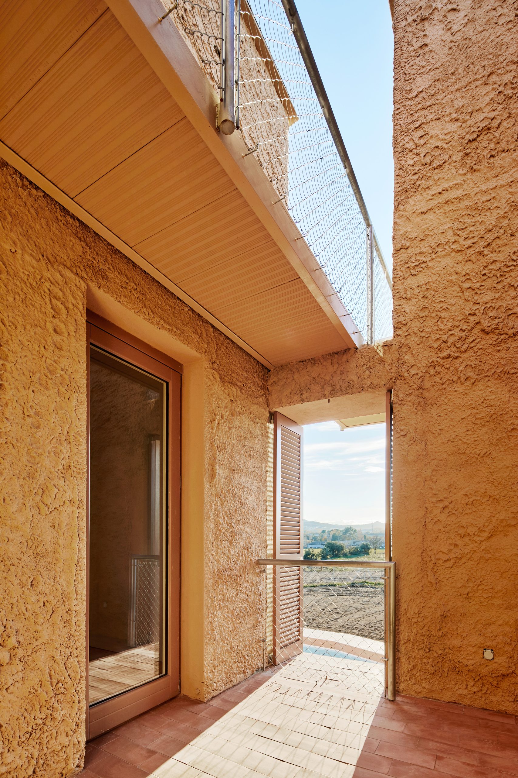 Balcony between textured walls at Can Migris