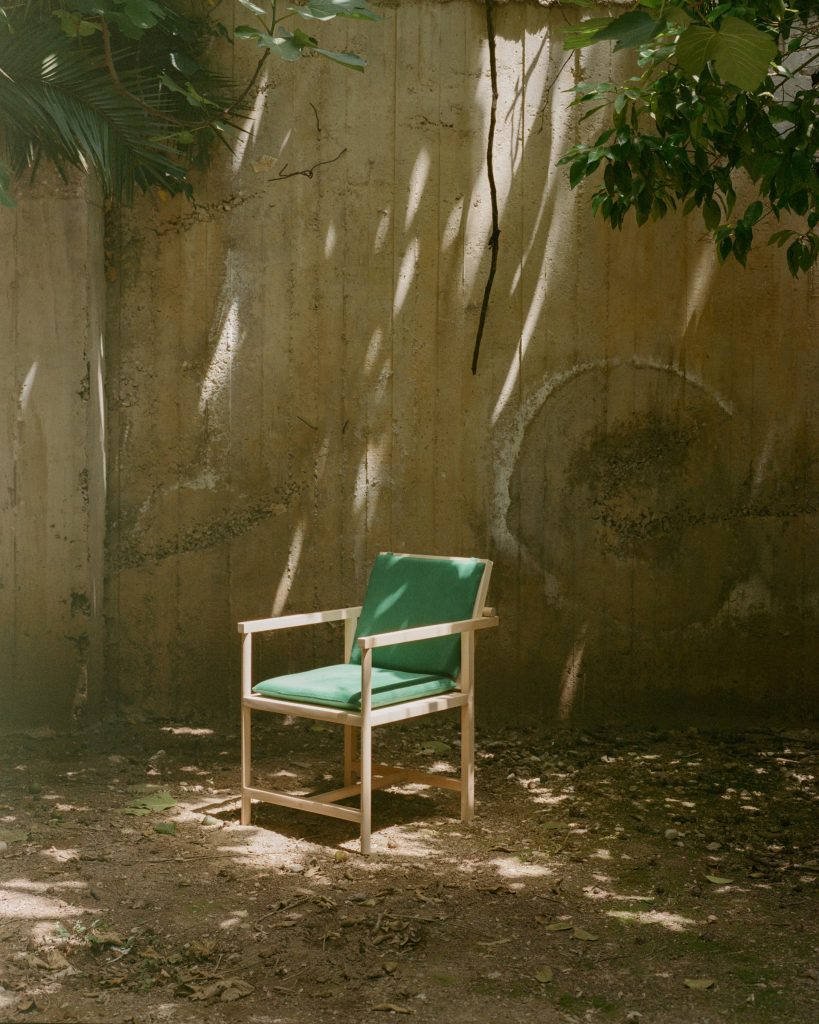 Parrot Chair beneath trees in an Athens courtyard