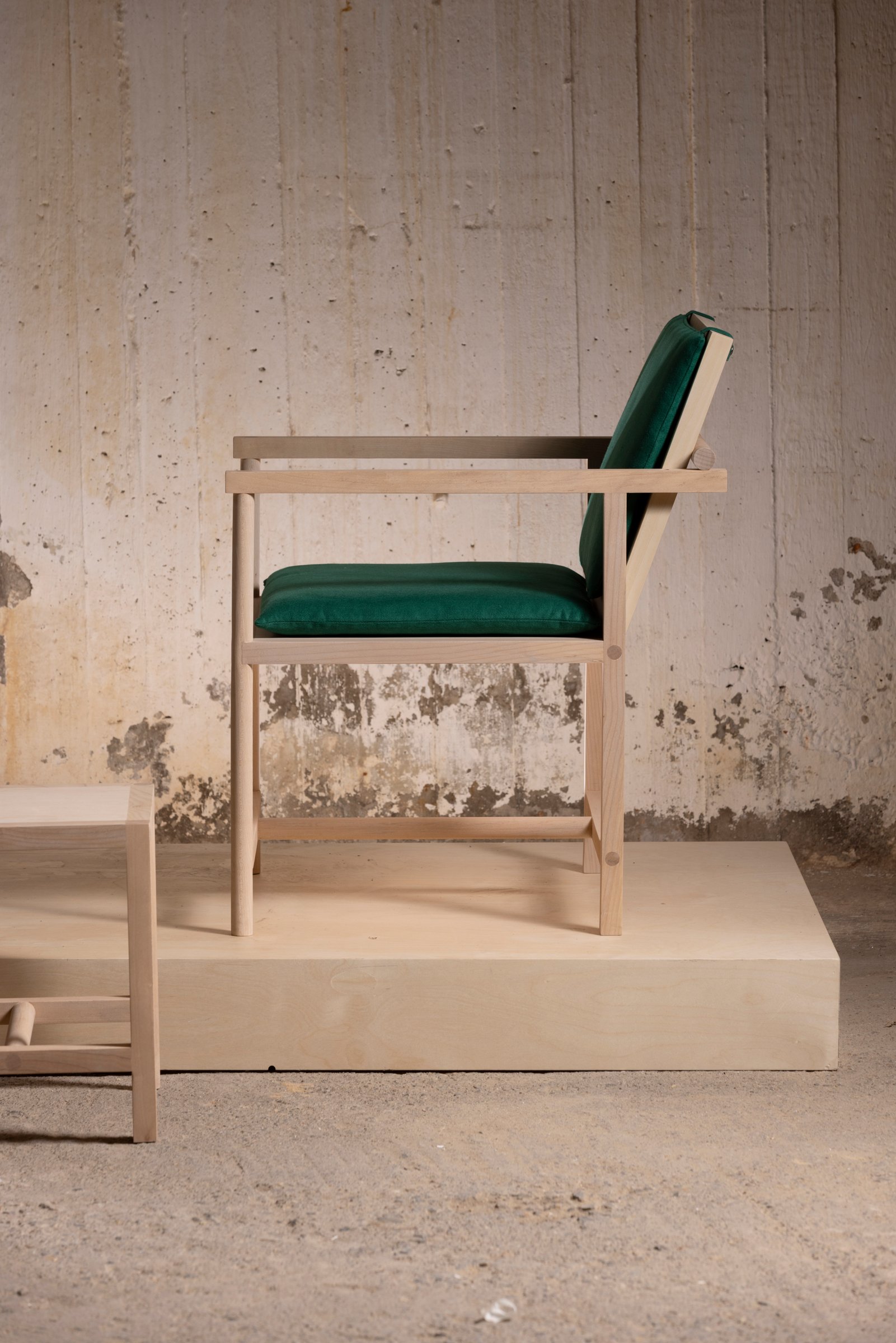 Side view of the Parrot Chair on a display plinth