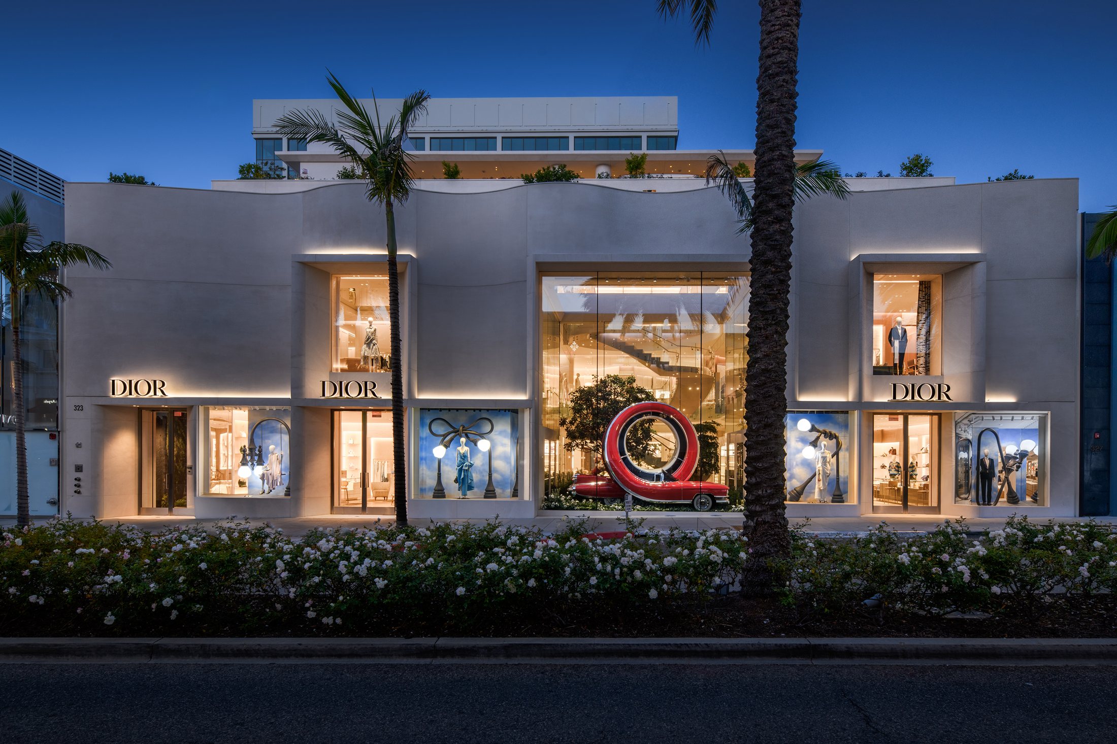 House of Dior Beverly Hills at dusk with illuminated sculptural displays