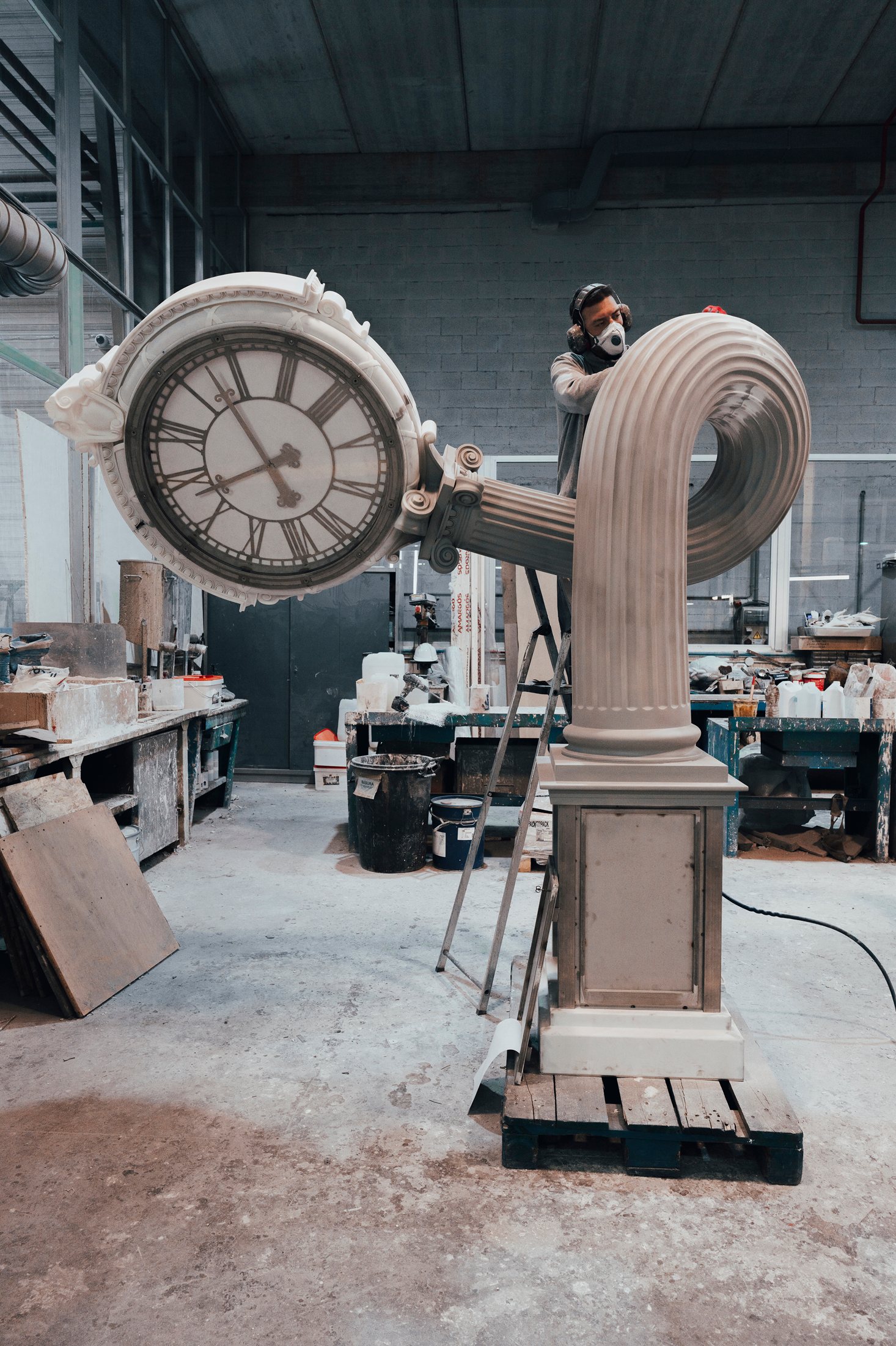 Craftsperson working on the looped clock column in the workshop