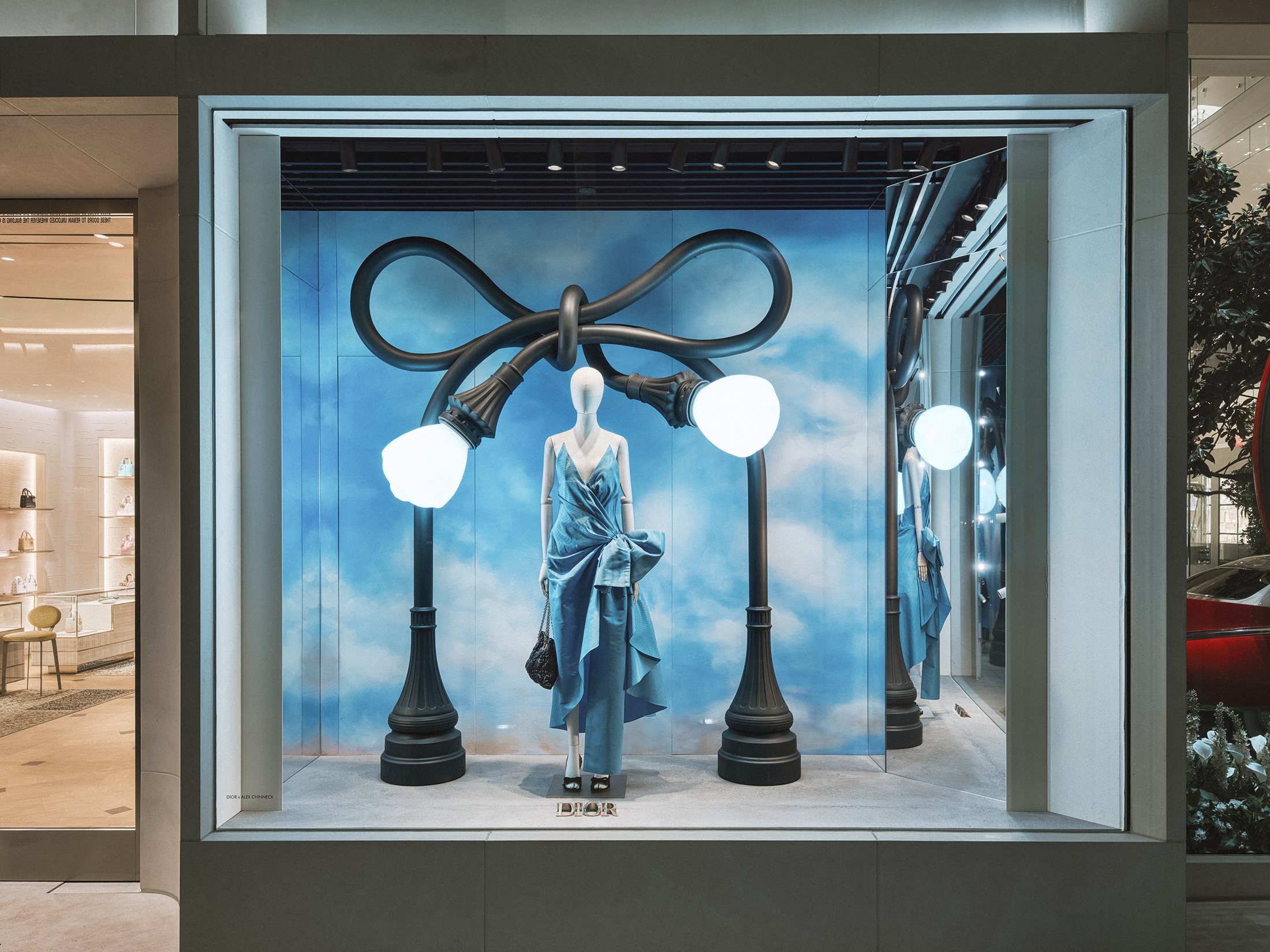 Bow-shaped street lamps framing a Dior dress in Beverly Hills