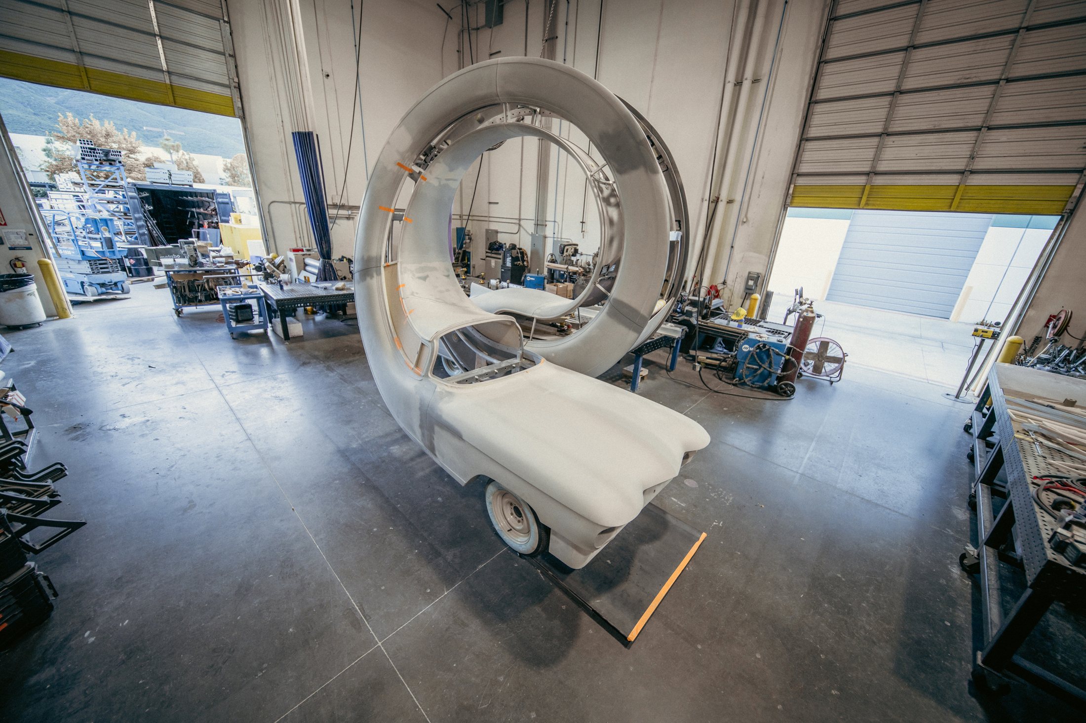 Unfinished looping car body with exposed supports in the workshop