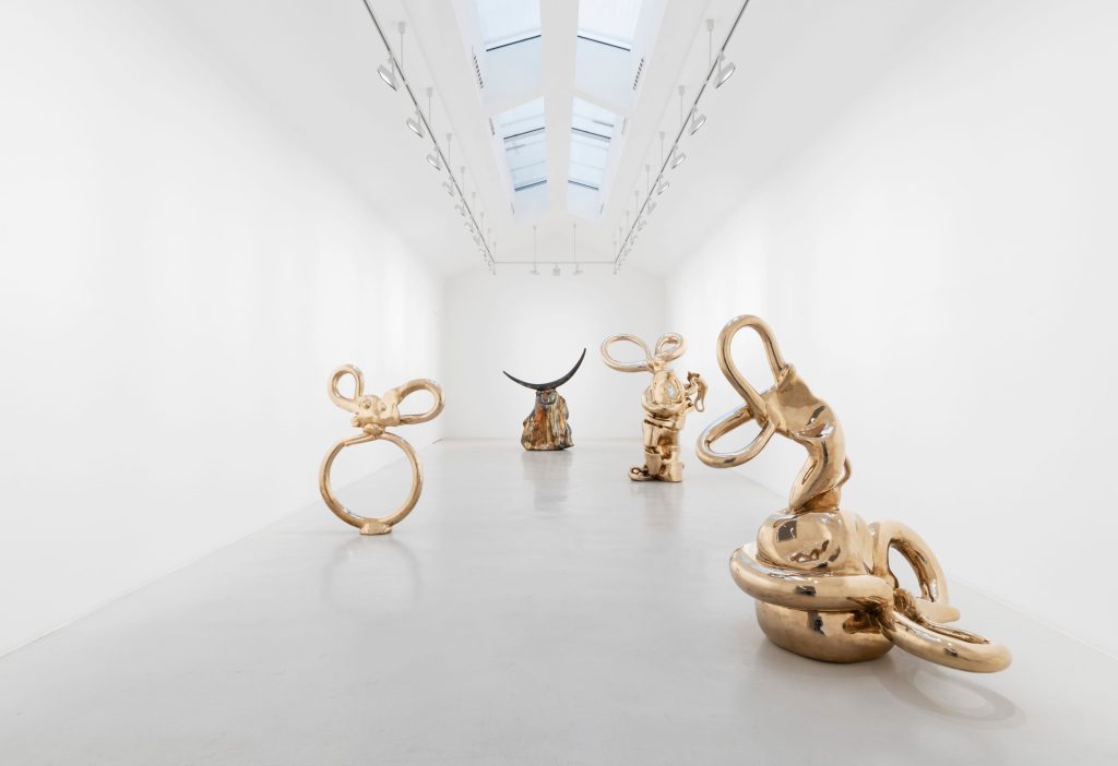 Looping and knotted bronze sculptures arranged beneath skylights at Perrotin Paris