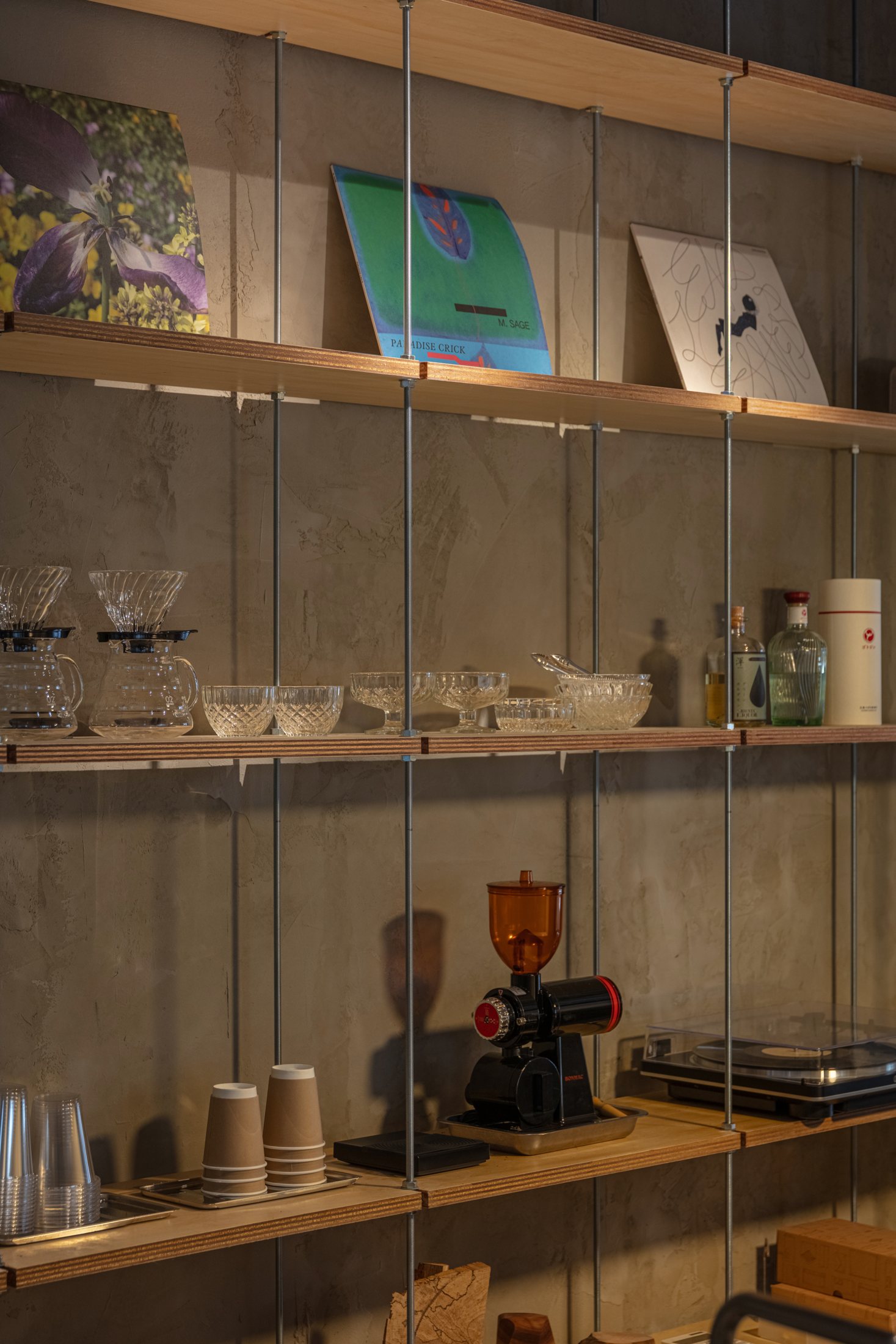 Suspended timber shelving displaying books and objects