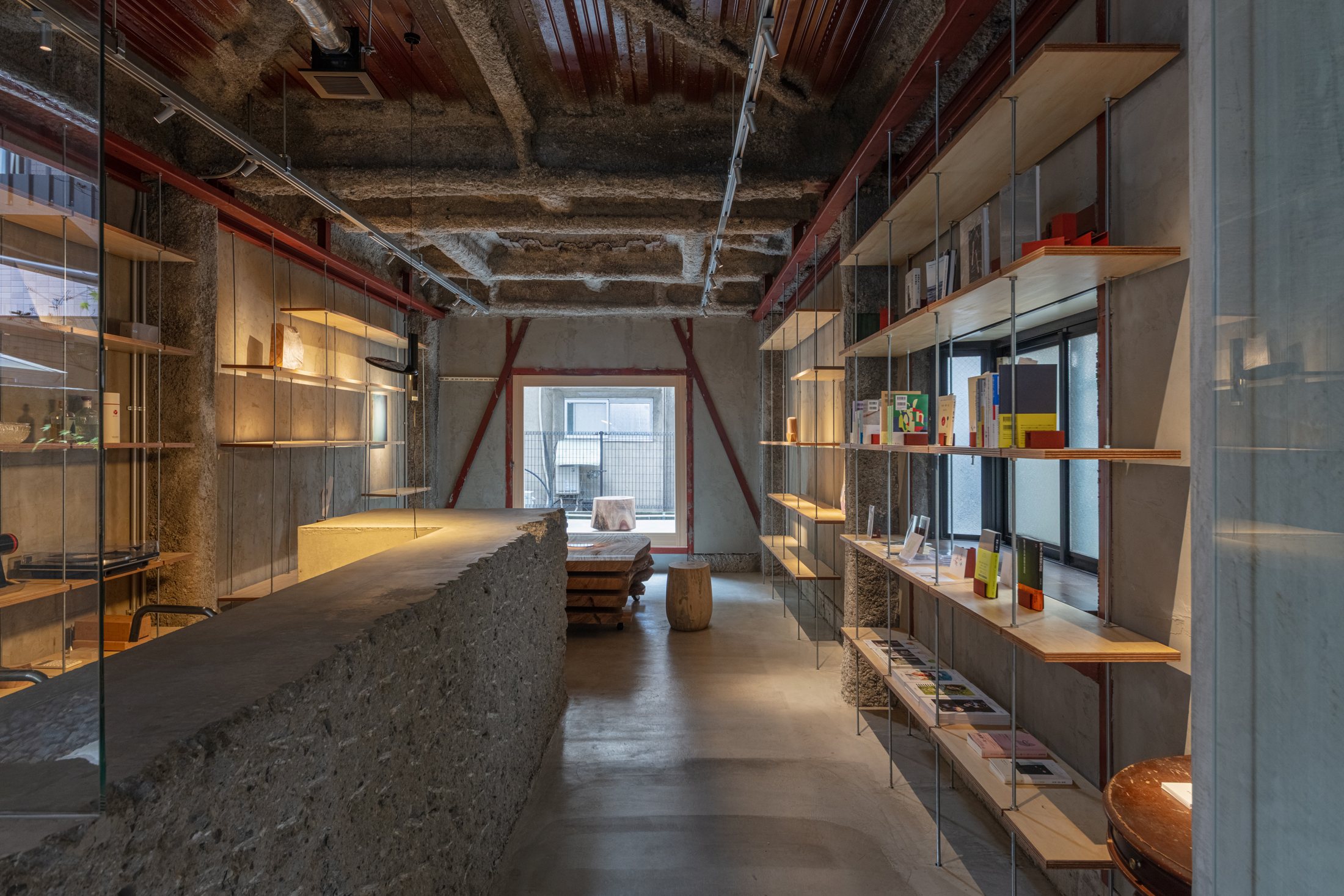 Maniwa gallery and bookstore interior with suspended shelves