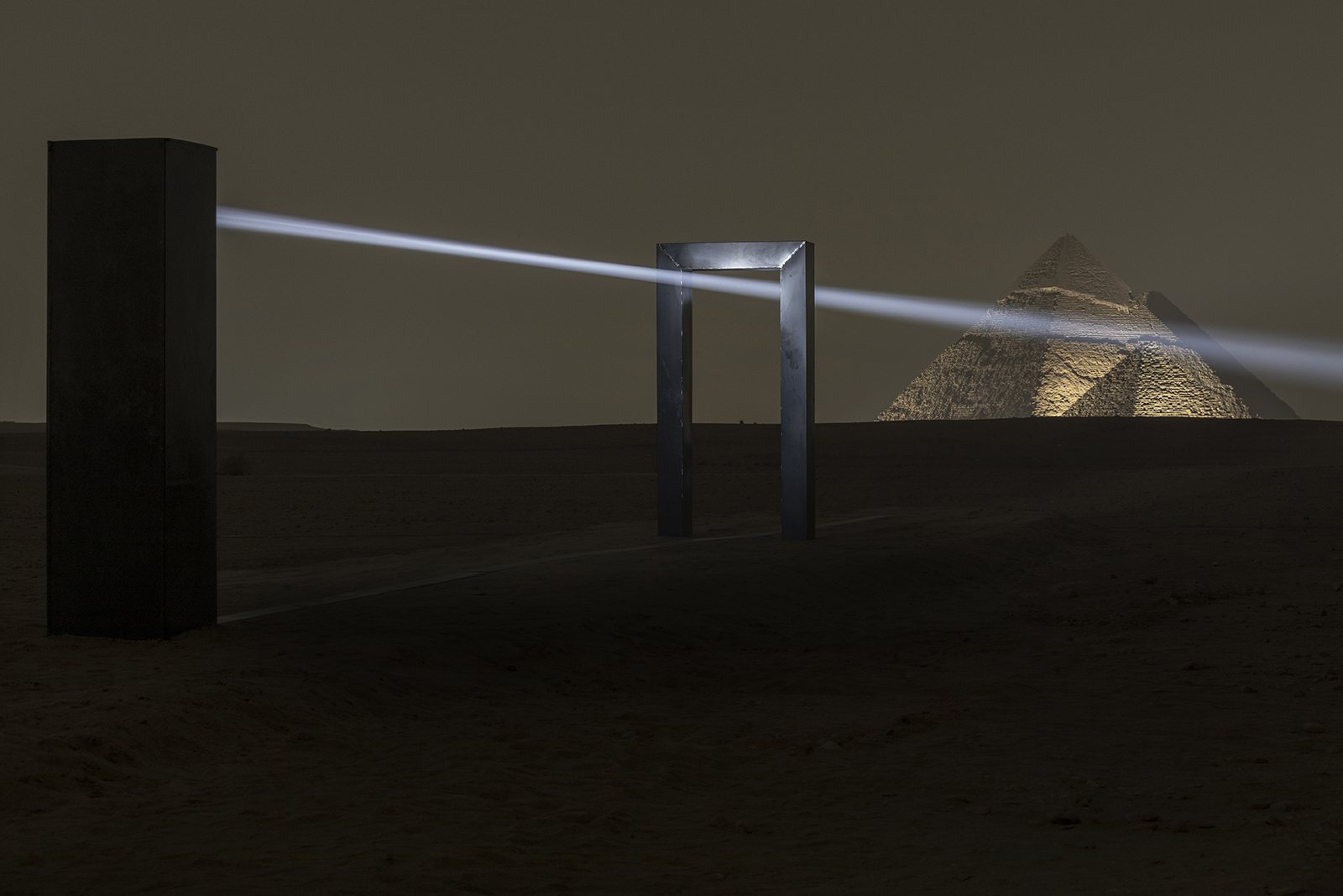 Portal of Light with a beam crossing between metal structures against the pyramids