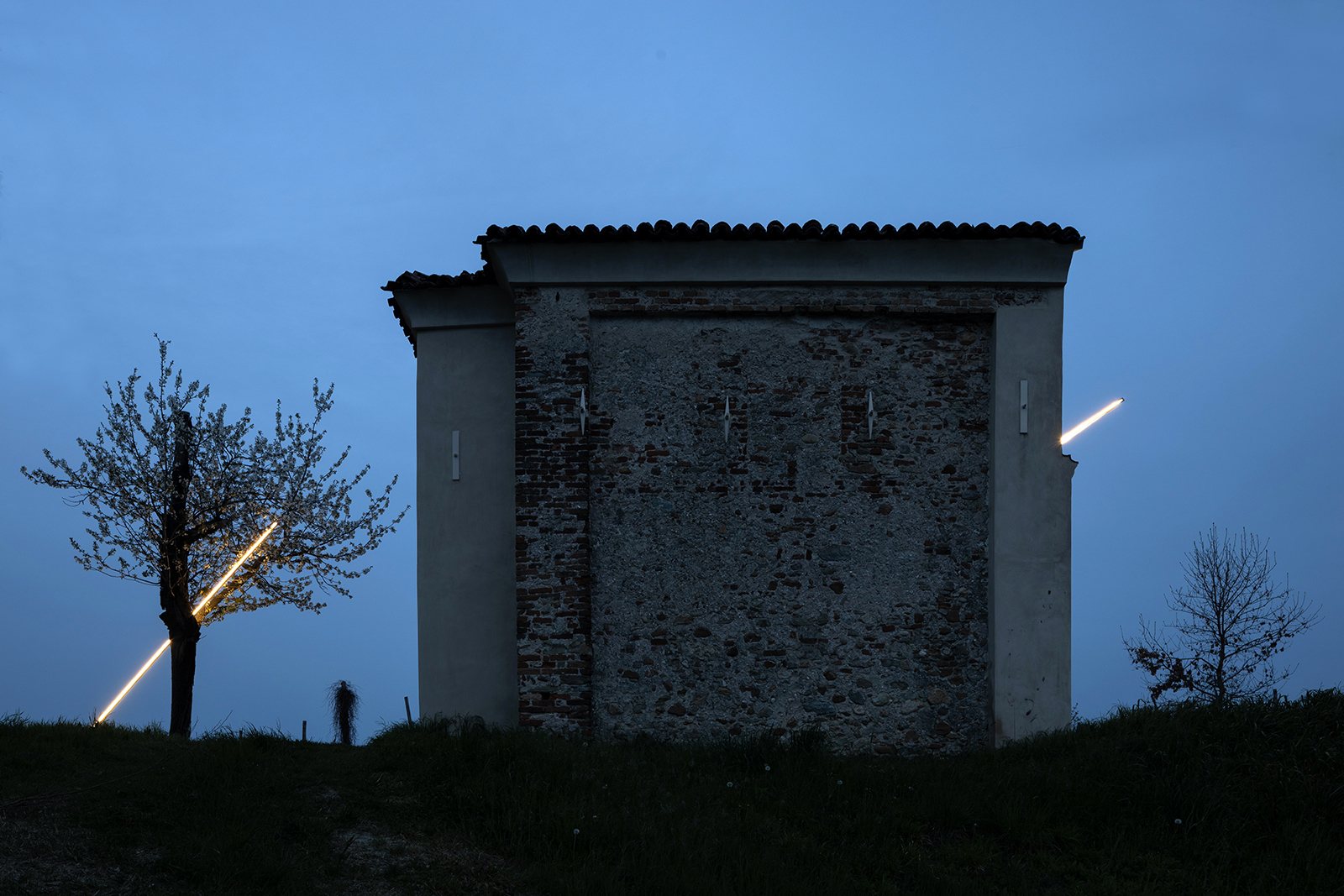 Miracle connecting a chapel and a tree at dusk