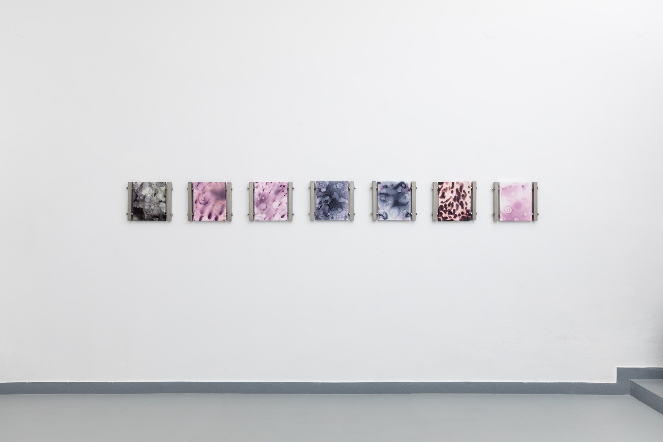 A row of small pink and blue works