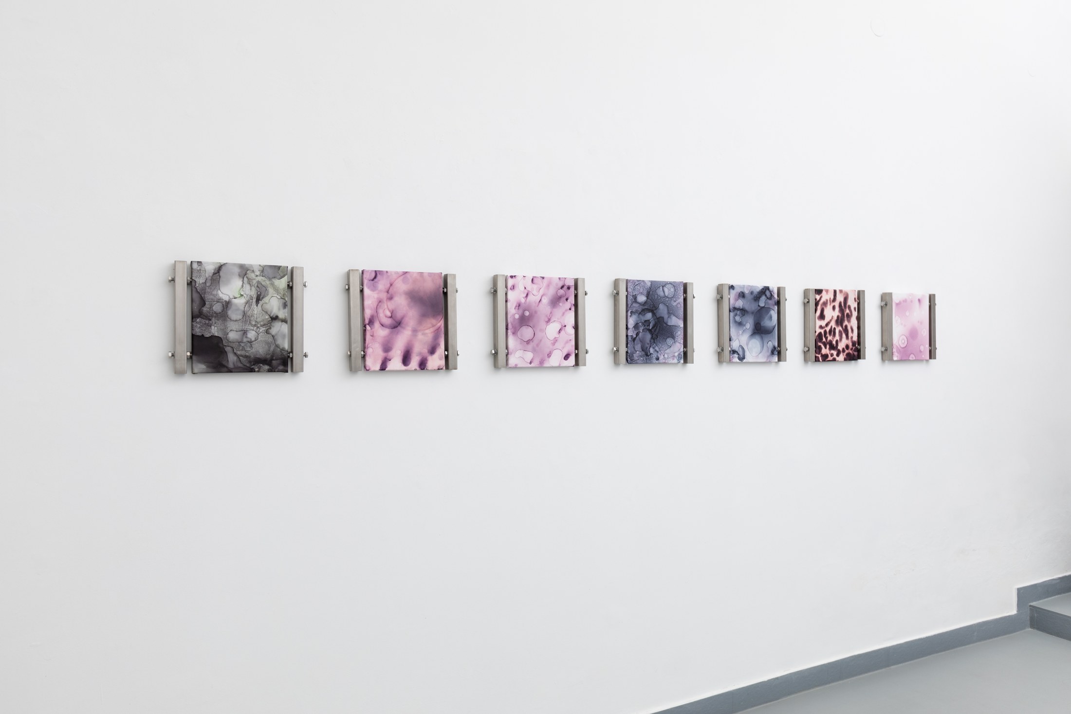 Small works displayed across a white gallery wall