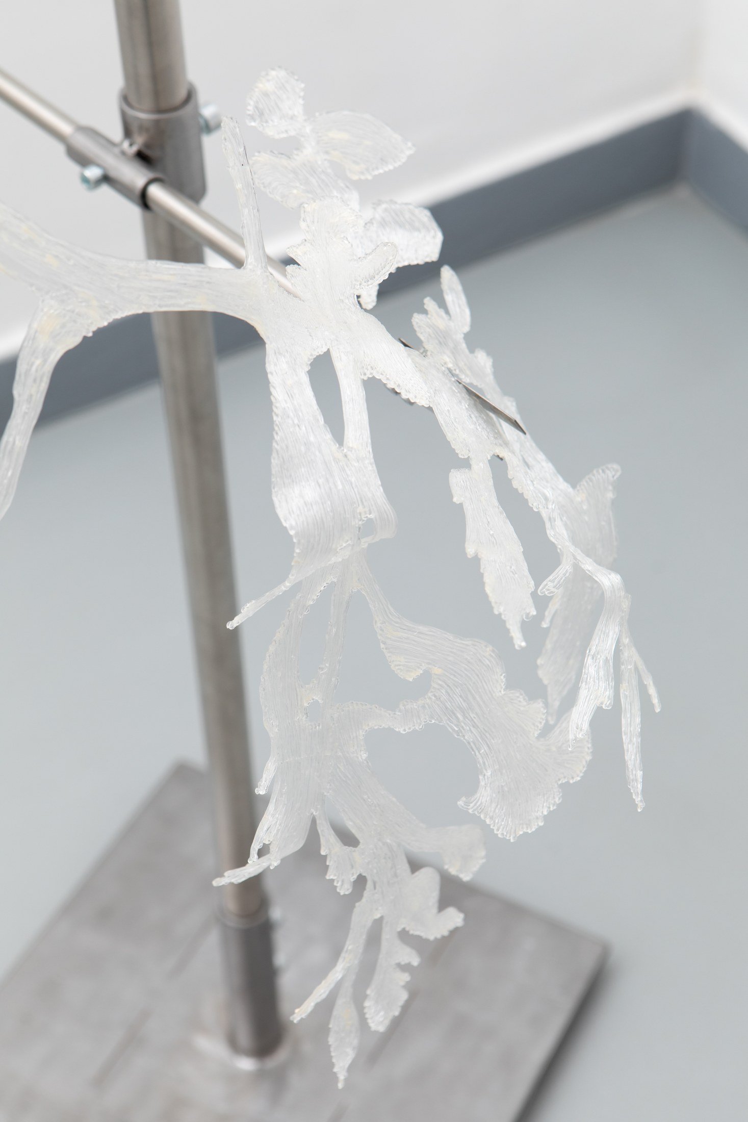Close-up of a sculptural structure supported by a metal stand