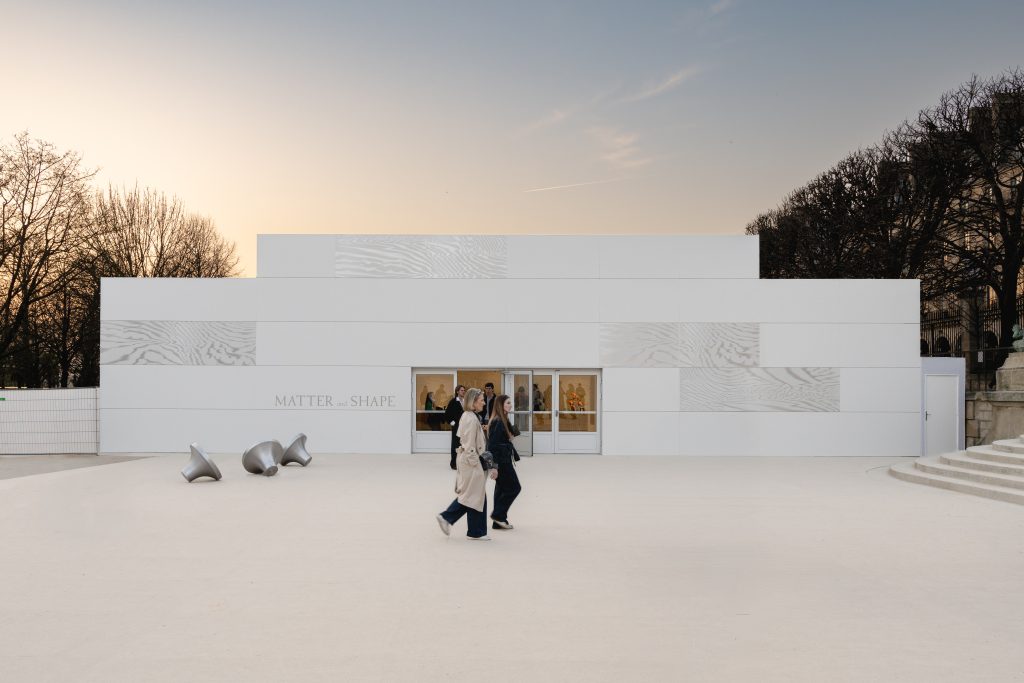 Stepped white pavilion with moiré panels at MATTER and SHAPE 2026 in the Jardin des Tuileries