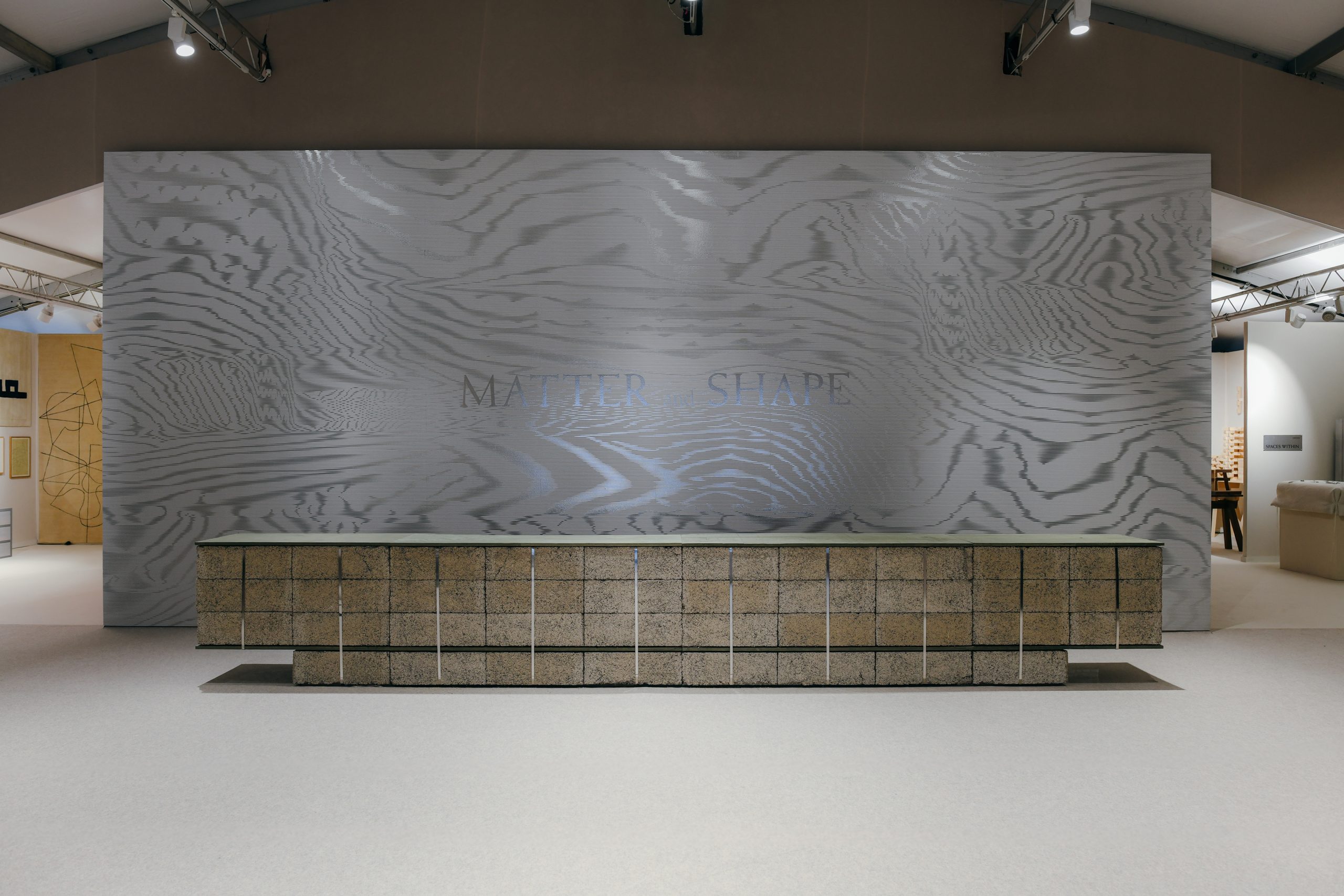 Moiré graphic wall above a hemp block reception counter
