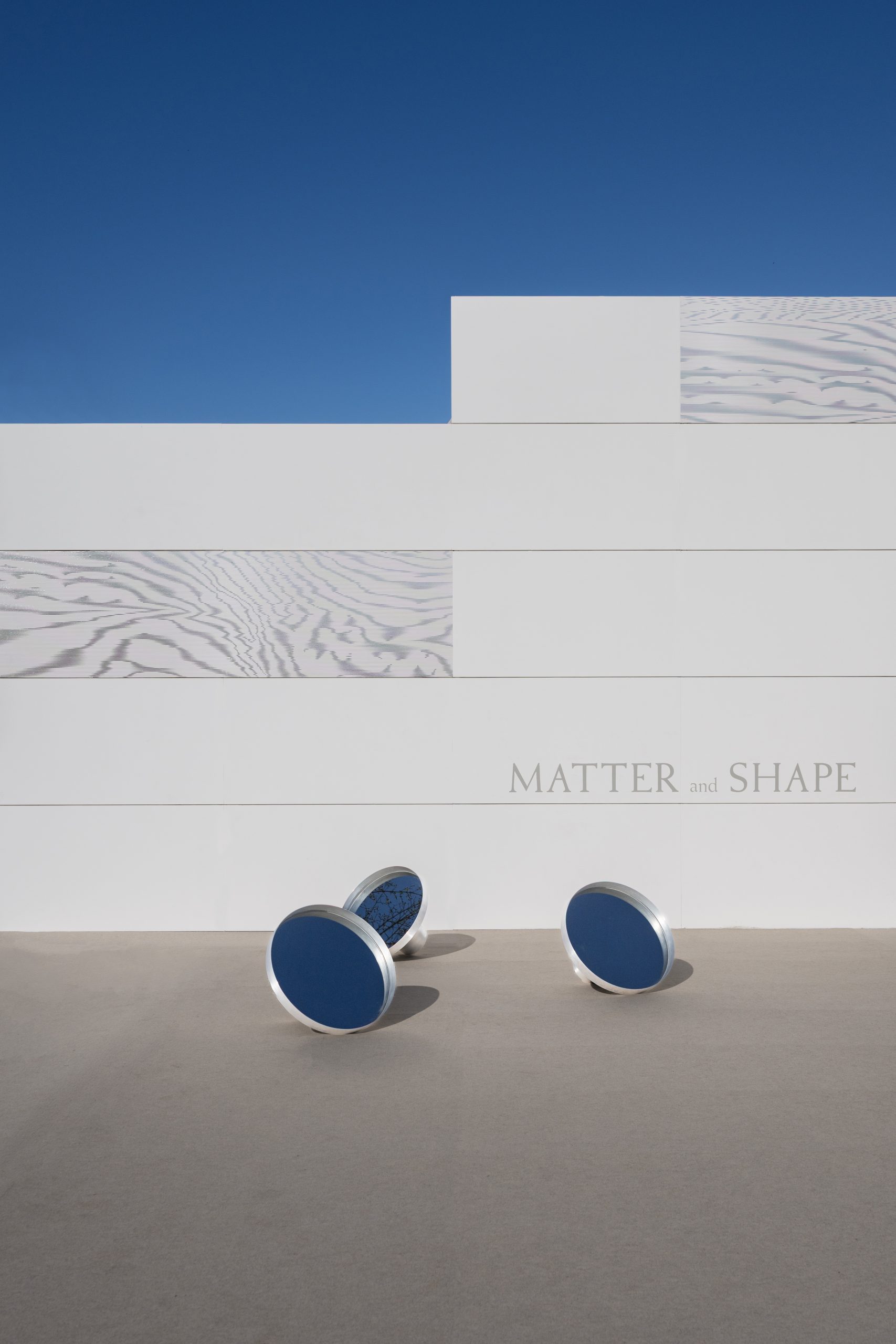 Moiré panels on the white pavilion exterior