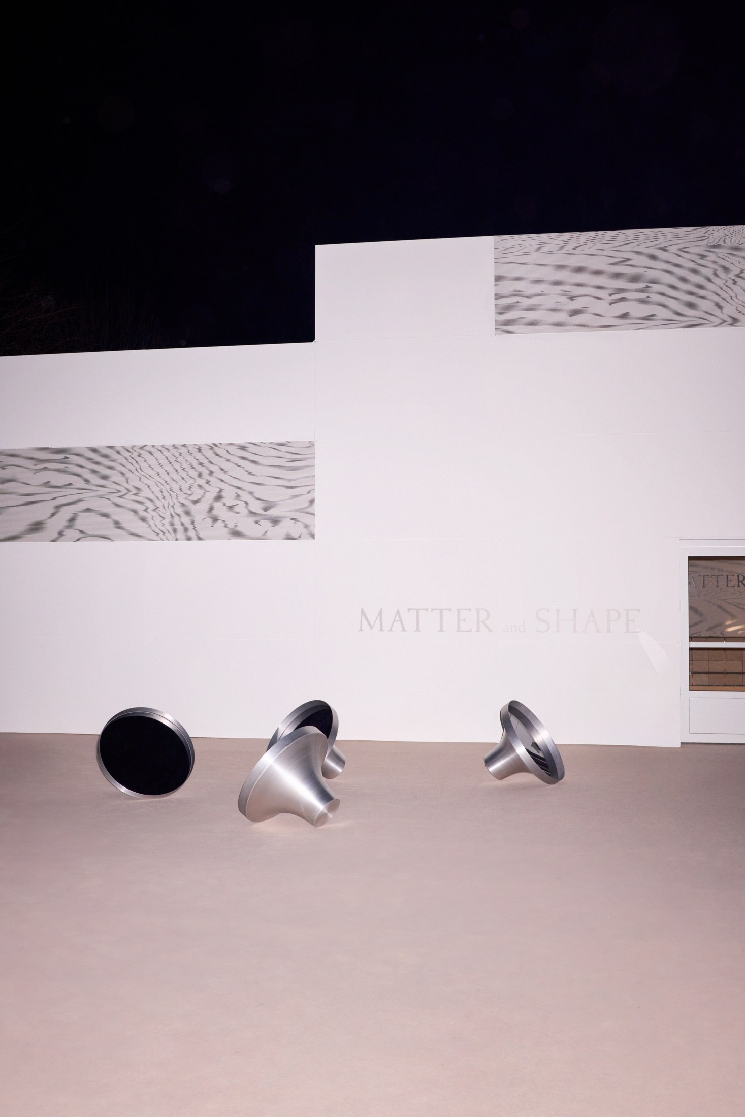 Illuminated pavilion façade at MATTER and SHAPE after dark