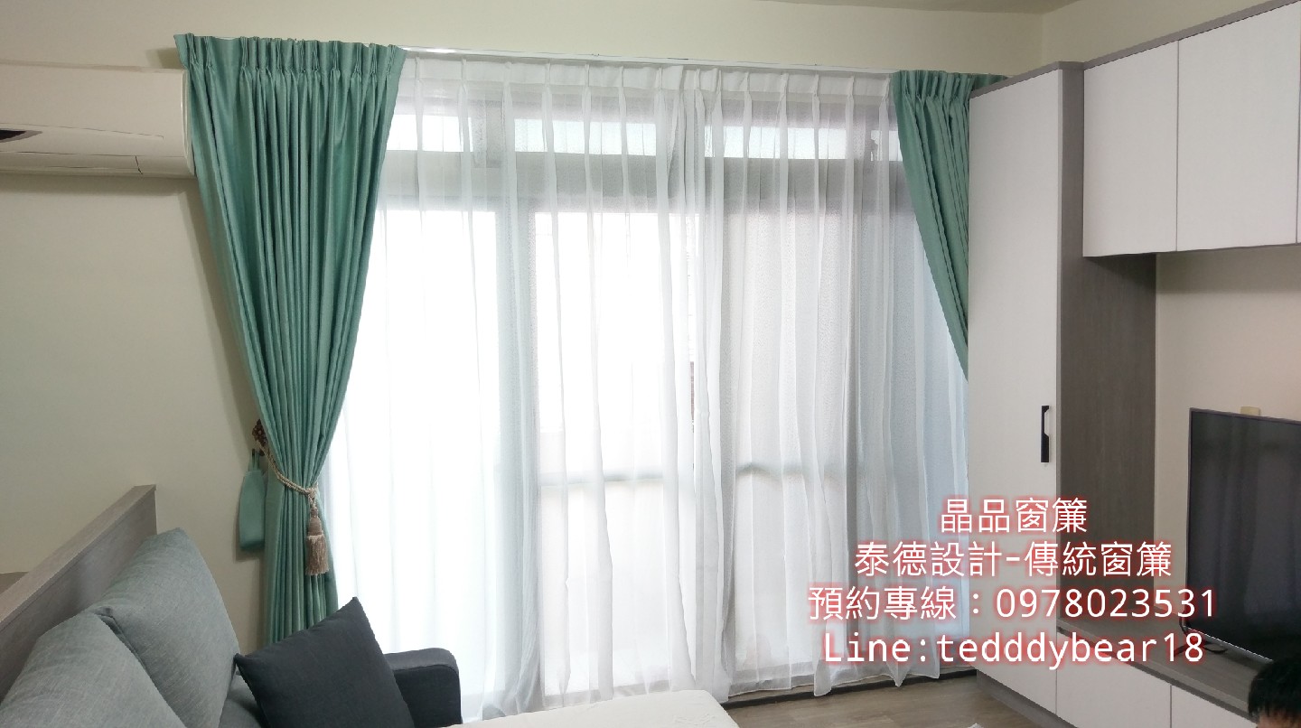 1) 照片中有一個客廳的角落，有一個沙發和兩個窗戶，其中一個窗戶有一個綠色的窗簾和白色的窗簾，另一個窗戶上只有白色的窗簾
