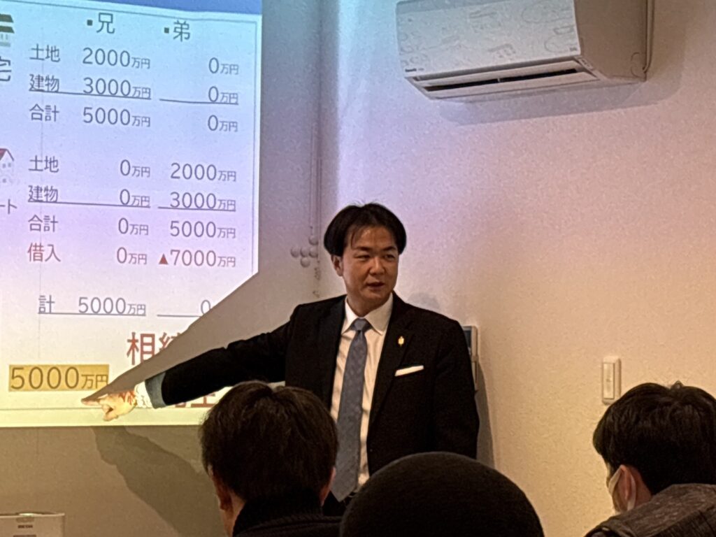 金沢市の後継者育成塾で、講師が賃貸経営と相続評価の専門スライドを示しながら解説している場面