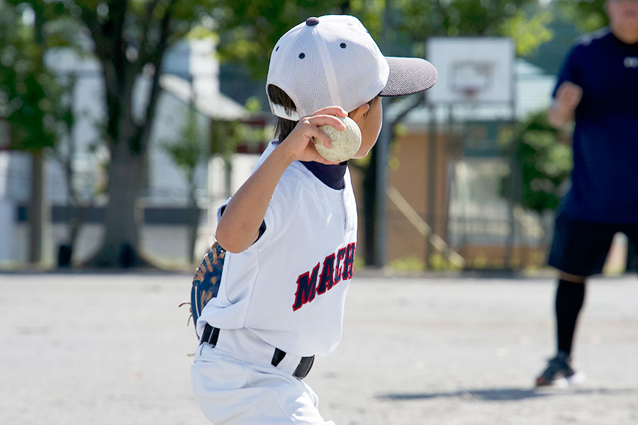投球する少年野球選手