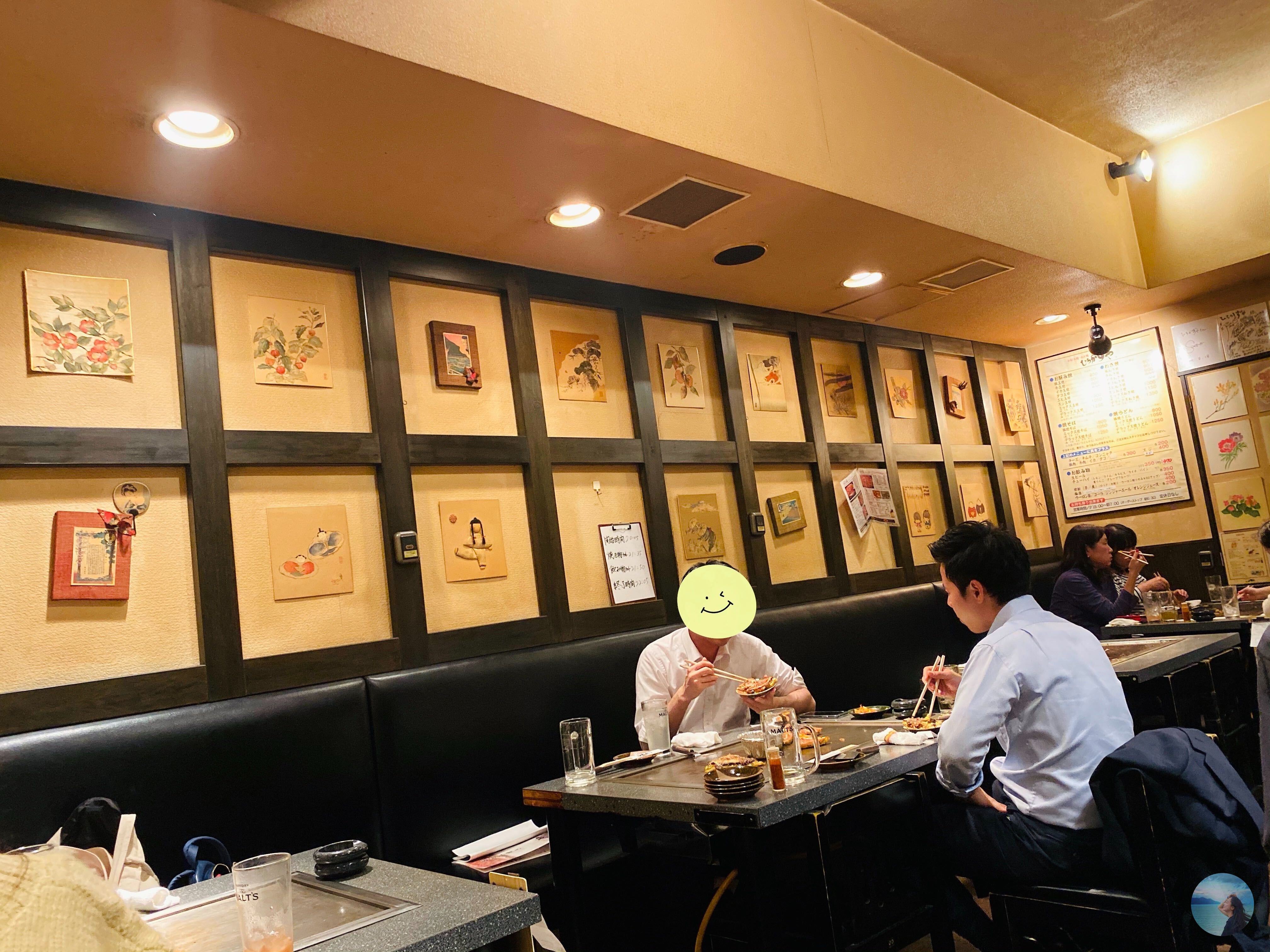 The space is decorated with many handmade paintings